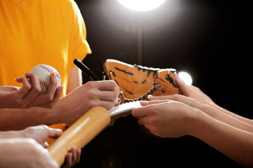 Autographs by baseball star on black and lights background