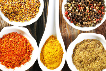 Different kinds of spices in ceramics spoons, close-up,