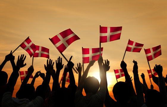 Silhouettes of People Holding Flags Denmark Concept