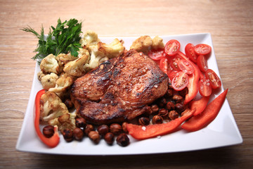 grilled meat cooked with nuts and vegetables serving