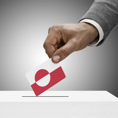 Black male holding flag. Voting concept - Greenland