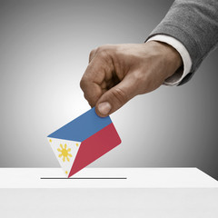 Black male holding flag. Voting concept - Philippines