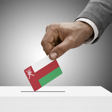 Black male holding flag. Voting concept - Oman