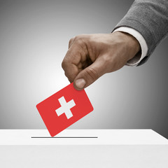 Black male holding flag. Voting concept - Switzerland