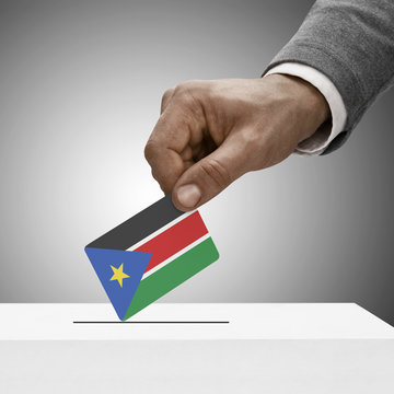 Black male holding flag. Voting concept - South Sudan