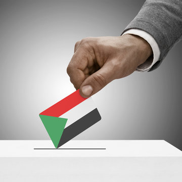 Black male holding flag. Voting concept - Sudan