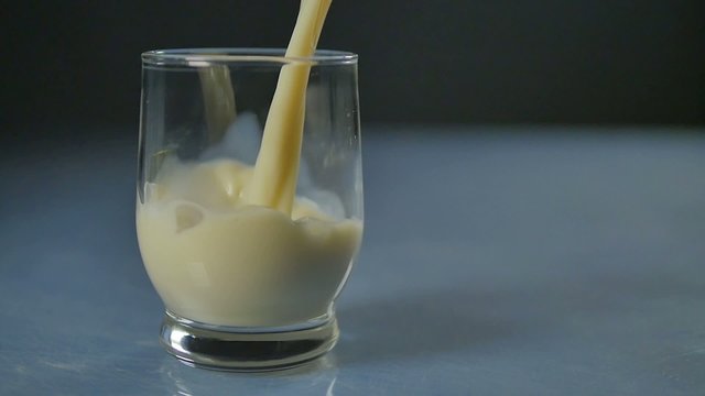 almonds poured into a glass, slow motion