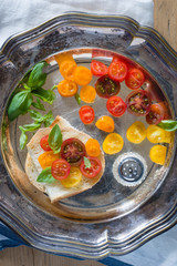 Bruschetta with a Mix of Red, Orange and Yellow Cherry Tomatoes