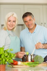 Happy mature couple making dinner together