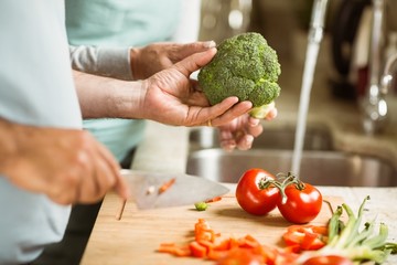 Mature couple preparing vegetables together