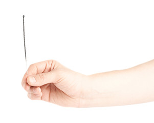 Male hand holding a sparkler isolated