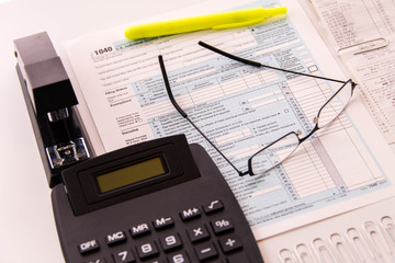 Tax preparation supplies, reading glasses and tax forms
