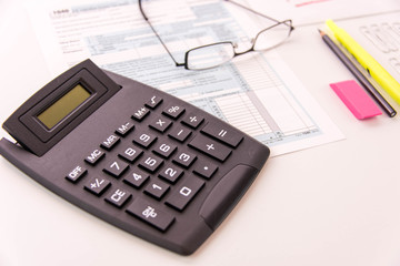 Tax preparation supplies, reading glasses and tax forms