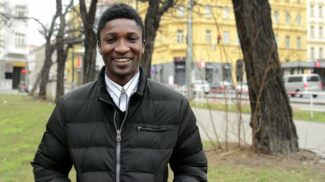 handsome black man laughs - urban street with cars - city