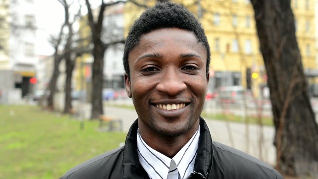 handsome black man laughs - urban street - closeup