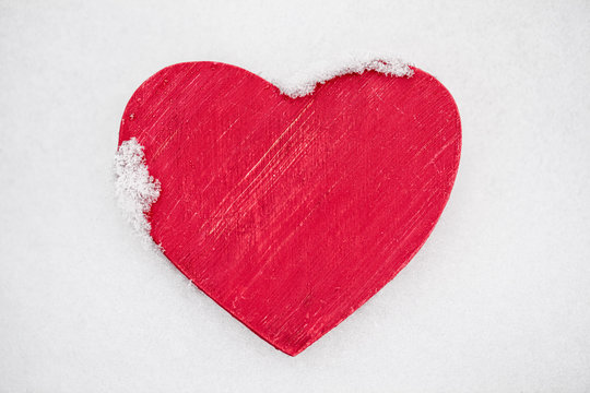 Red heart in snow