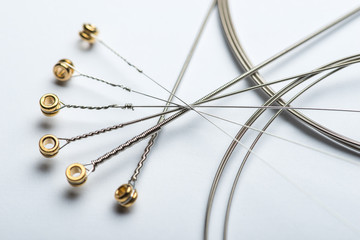 Electric guitar strings on white surface