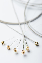 Electric guitar strings on white surface