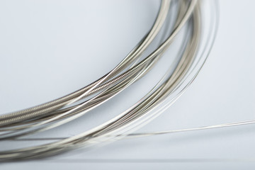 Electric guitar strings on white surface