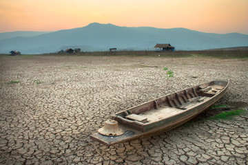 wood boat on cracked earth