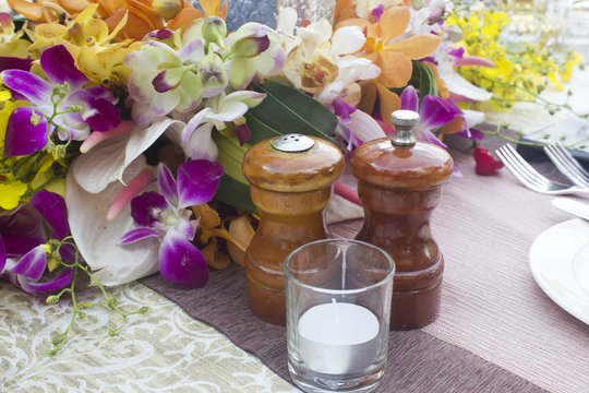 Jars, salt and pepper on the table Dinner with flowers.