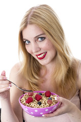 Model Released. Attractive Young Woman Eating Breakfast Cereal