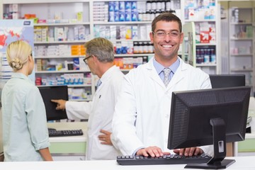 Happy pharmacist looking at camera