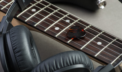 Fototapeta premium Electric guitar with headphones and mediator