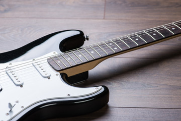 Electric guitar on a brown wooden floor