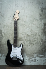 Fototapeta na wymiar Electric guitar near the concrete wall