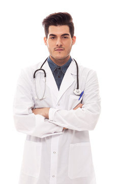 Male doctor is standing with crossed hands over white isolated b