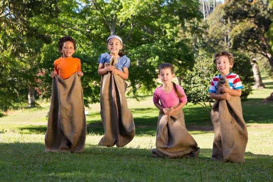 Children having a sack race in park