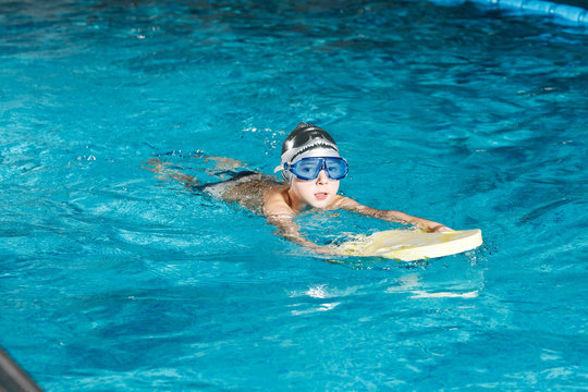 Activities on the pool young boy swimming fitness