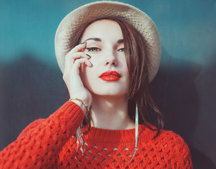 Young beautiful hipster girl in red jersey with hat