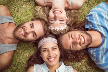 Hipsters lying on grass smiling
