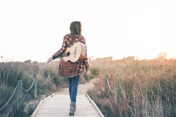 Beautiful Young Woman with guitar at Outdoors