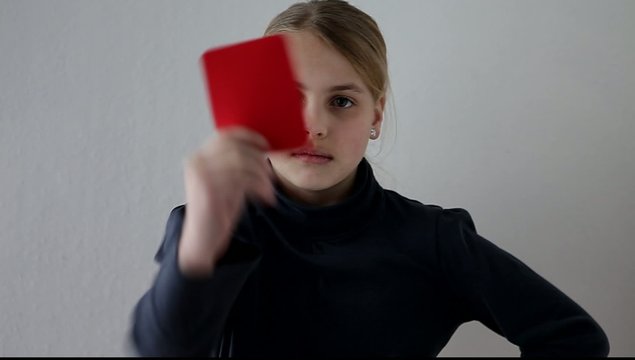 girl showing a red card
