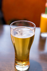 Glass beer on wood background, selective focus
