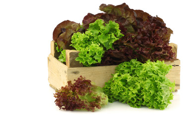 assorted lettuce in a wooden box on a white background