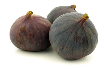 three figs (Ficus carica) on a white background