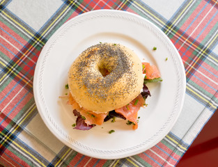 bagel with salmon, fresh cheese and salad.