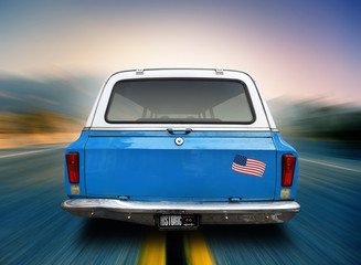 Fototapeta premium Blue car is moving along the American highway