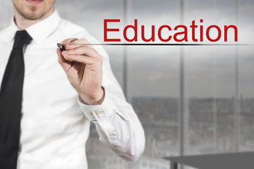 businessman writing education in the air