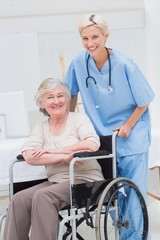 Female nurse pushing senior patient in wheelchair