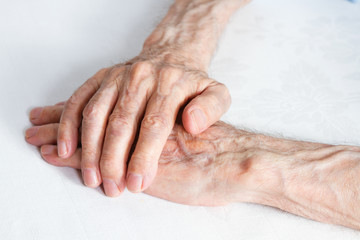 Old people holding hands. Closeup.