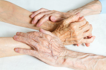 Fototapeta premium Old people holding hands. Closeup.