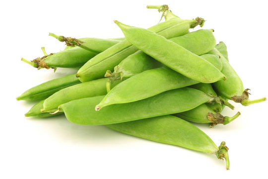 green pea pods on a white background