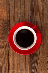 Coffee cup and saucer on  wooden table.