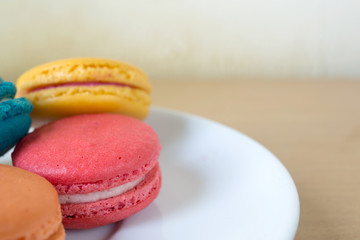 French macaroons on plate, with vintage pastel