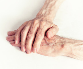 Fototapeta premium Old people holding hands. Closeup.